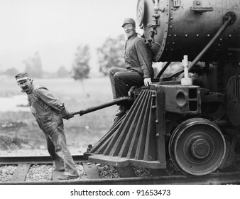Engineers pulling train engine