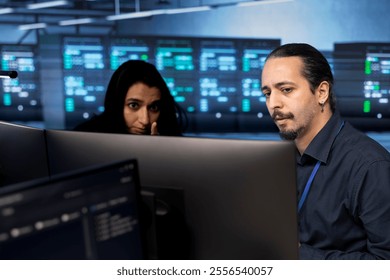 Engineers reconfiguring server farm to optimize it for data processing requirements of customers. IT professionals ensuring that data center equipment operates efficiently