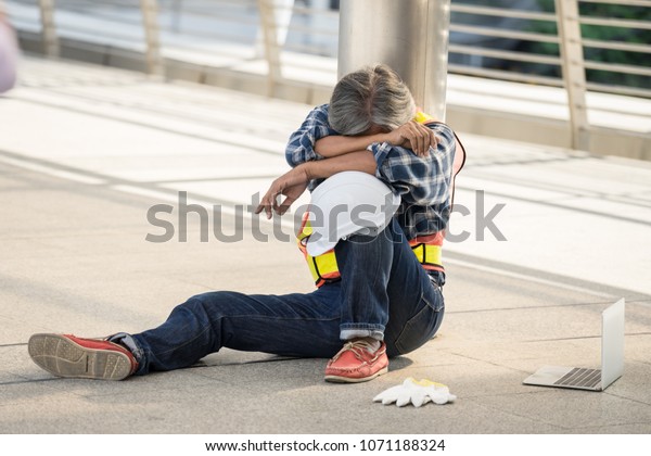 Engineers Sitting Hugging Their Knees Resting Stock Photo (Edit Now