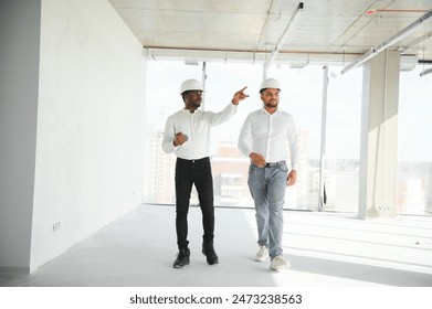 engineers team are discussing while inspecting at construction site.