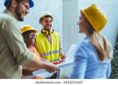 Engineers team with draft plan of building and tablet talking constructing site. Construction manager and engineer working on building site. Team of construction workers discussing