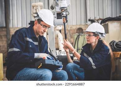 Engineers team mechanic using computer controller Robotic arm for welding steel in steel factory workshop. Industry robot programming software for automated manufacturing technology - Powered by Shutterstock