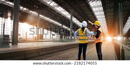 
Engineers technician team checkup and analyzing an unfinished on railway station construction project with software and blueprint, Design and plan construction, Teamwork. 