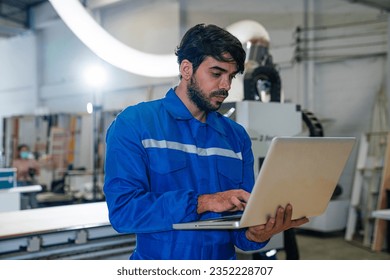 engineers and technician using laptop checking and repair pressing metal machine at factory, Machine maintenance technician operation concept.