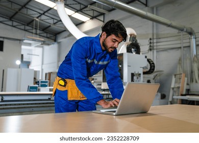 engineers and technician using laptop checking and repair pressing metal machine at factory, Machine maintenance technician operation concept.