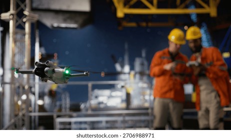 Engineers technicians using drone for remote operations and aerial mapping on offshore rig, improving logistics, planning and modern maintenance through advanced technology.