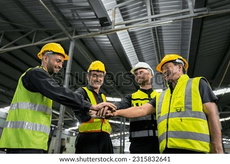 Engineers and technicians and workers, working together as a team, are joining forces to work on a grand project, industrial warehouse warehouse backdrop.