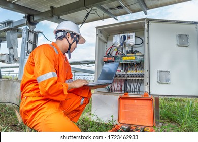 Engineers upload data of power energy to a laptop for checking the performance of the solar panel to confirming systems working normally. Concepts professional engineer for the Solar cell power plant.