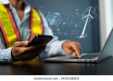 Engineers use AI artificial intelligence to inspect wind turbines and analyze the data of the electricity generated using hologram HUD. Clean energy technology and renewable energy. - Powered by Shutterstock