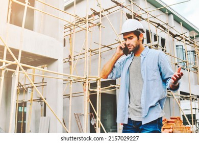 Engineers use cell phone to order workers at construction site.