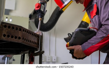 Engineers Use A Wireless Remote Control Of Robotic Welding And Robot Gripping Working On Smart Factory.