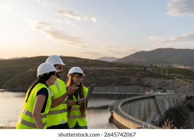 Engineers using laptop analyzing data at hydroelectric power plant dam - Powered by Shutterstock - Get 15% off with code: PIKWIZARD15