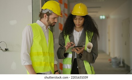 Engineers using tablet talking and brainstorming together on construction site, Real estate building project with civil engineer, Architects workers discussing plan details at workplace