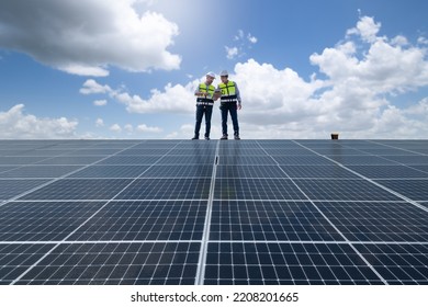 Engineers walking on roof inspect and check solar cell panel by hold equipment box and radio communication ,solar cell is smart grid ecology energy sunlight alternative power factory concept. - Shutterstock ID 2208201665