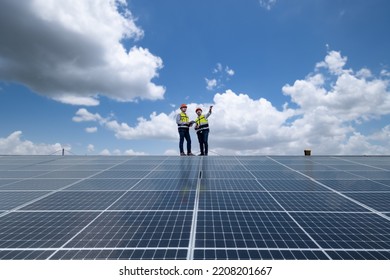 Engineers walking on roof inspect and check solar cell panel by hold equipment box and radio communication ,solar cell is smart grid ecology energy sunlight alternative power factory concept. - Shutterstock ID 2208201667