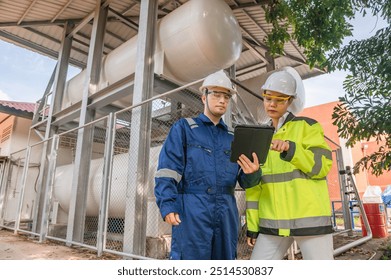 Engineers work place to keep liquid helium,preventive maintenance schedule checking,Thailand people,Technicians and engineers discuss work together.