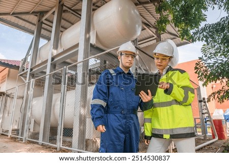 Engineers work place to keep liquid helium,preventive maintenance schedule checking,Thailand people,Technicians and engineers discuss work together.