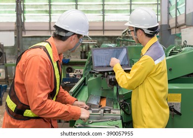 Engineers and worker discussing work together in factory