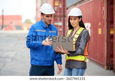 Engineers or workers using laptop computer and talking about work in containers warehouse storage