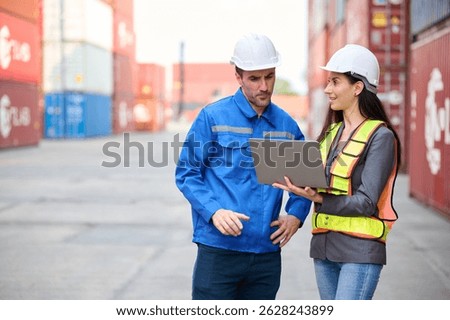 Engineers or workers using laptop computer and talking about work in containers warehouse storage