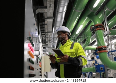 Engineers working in the main control room of a state-of-the-art chiller HVAC system.