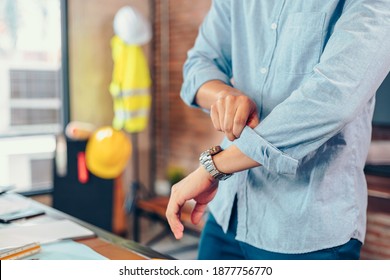 Enginner Roll Up The Sleeves Before Working At Workplace.