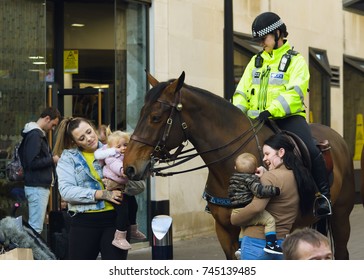 England, Bristol - Oct 30, 2017: Members Of Public And Friendly Mounted Police Officer, Small Babies Touching Horse