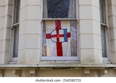 England Flag, The Cross Of St George, A Show Of Patriotism In The Window Of A Victorian Town House In An Urban Area