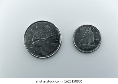 England UK 24/01/2020 A 25 Cents and 11 Cents silver Canadian coin, depicting a Moose Head and a Sailing Yacht