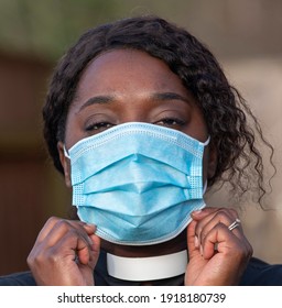 England, UK, December 2020. A Black Minister Wearing A Protective Medical Mask And White Collar During Coronavirus Outbreak