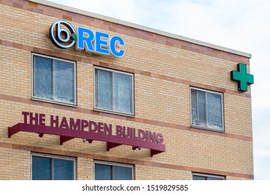 Englewood, Colorado / United States of America - September 7 2019 : Top of the Hampden Building with medical and recreational marijuana symbols on brick exterior.