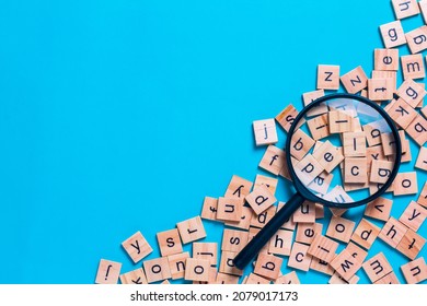English alphabet made of square wooden tiles with the English alphabet scattered on blue background. The concept of thinking development,grammar. - Shutterstock ID 2079017173