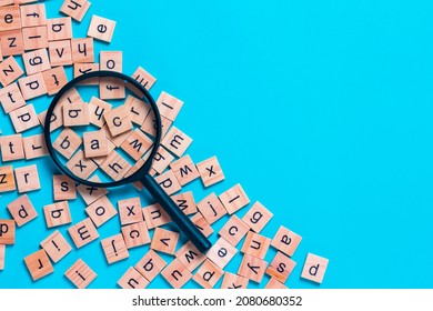 English alphabet made of square wooden tiles with the English alphabet scattered on blue background. The concept of thinking development,grammar. - Shutterstock ID 2080680352