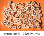 English alphabets wooden lettered tiles on an orange background