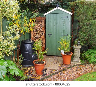 English back garden in Autumn with shed and log store