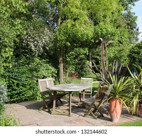 English Back Garden Patio With Table And Chairs