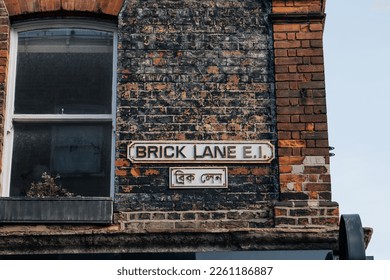 English and Bengali bilingual street name sign on a building in Brick Lane, London, UK.