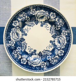 English Blue And White Floral Pattern China Plate On Plaid Tablecloth