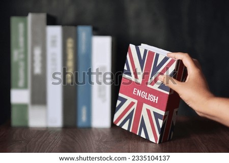 English book is selected from the bookshelf. Learning English fluently are advantages such as can connect to the foreigner, new bussiness, make more money, Increased Brainpower and Immigration Benefit