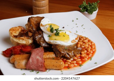 English Breakfast Consist Of Fried Sunny Side Eggs, Turkey Bacons, Sausages, Bake Beans, Croissant, Hash Brown With Seasonal Fruit Jam And Butter