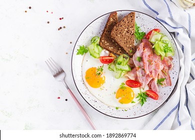 English Breakfast - Fried Egg, Bacon, Tomatoes  And Bread. Top View, Flat Lay, Overhead