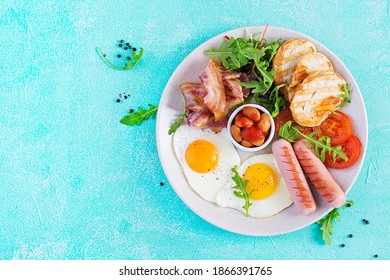 English Breakfast - Fried Egg, Beans, Tomatoes, Sausage, Bacon And Toast. Top View, Flat Lay, Overhead