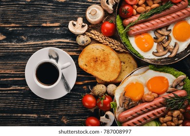 English Breakfast - Fried Egg, Beans, Tomatoes, Mushrooms, Bacon And Toast. Top View. On A Wooden Background.