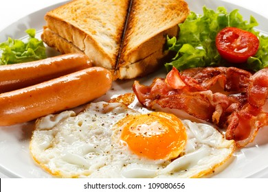 English breakfast - toast, egg, bacon and vegetables on white background