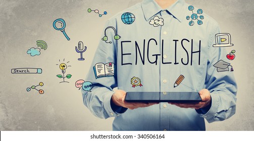 English concept with young man holding a tablet computer  - Shutterstock ID 340506164