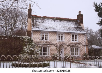 English Country Cottage In The Winter Snow