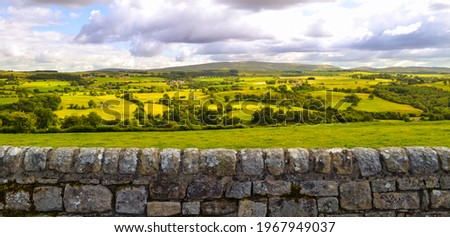 English countryside and farmland landscape panorama background along Hadrian's Wall Roman ruin. Beautiful rural country side pastures in England