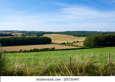 English Countryside. Typical View Of The English Landscape On A Summers Evening. Mixed Land Use Woods And Farming.