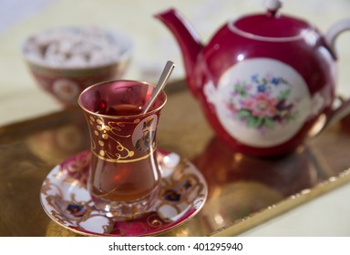 English cup of tea with teapot, sugar and biscuits
