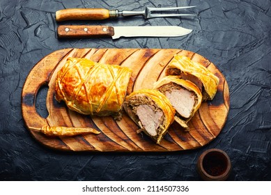 English dish of beef tenderloin in puff pastry stuffed with mushrooms. Wellington Meat